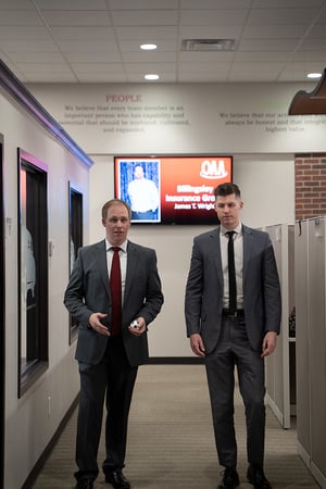 two men walking through their office