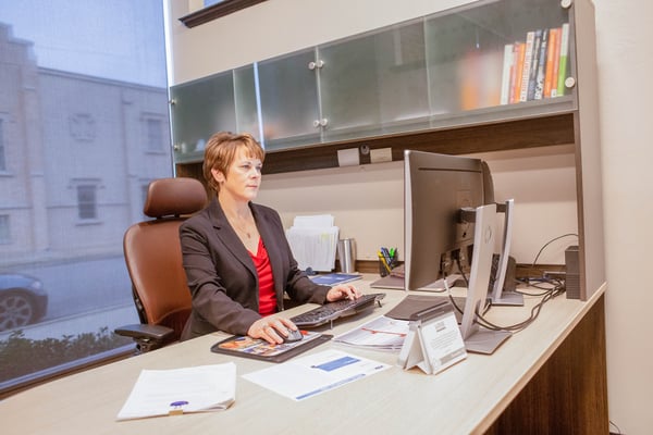 business woman working at her desk in front of a computer