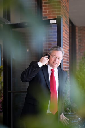 man outside talking on a cell phone