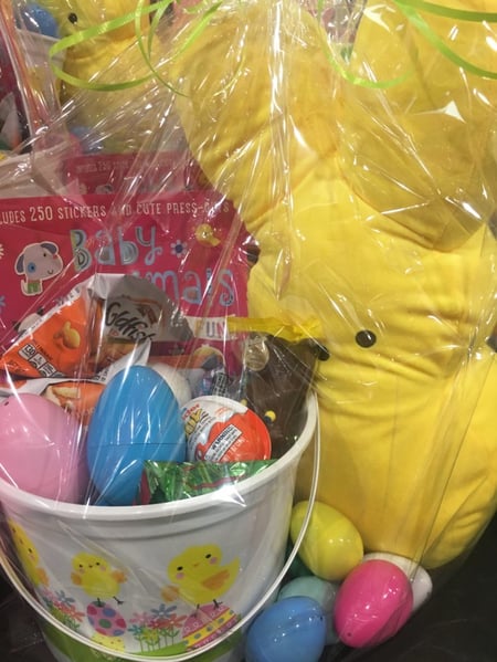 close up of an easter bucket with toys and candy 