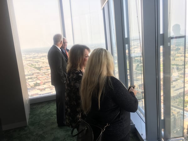 four people looking out over the city