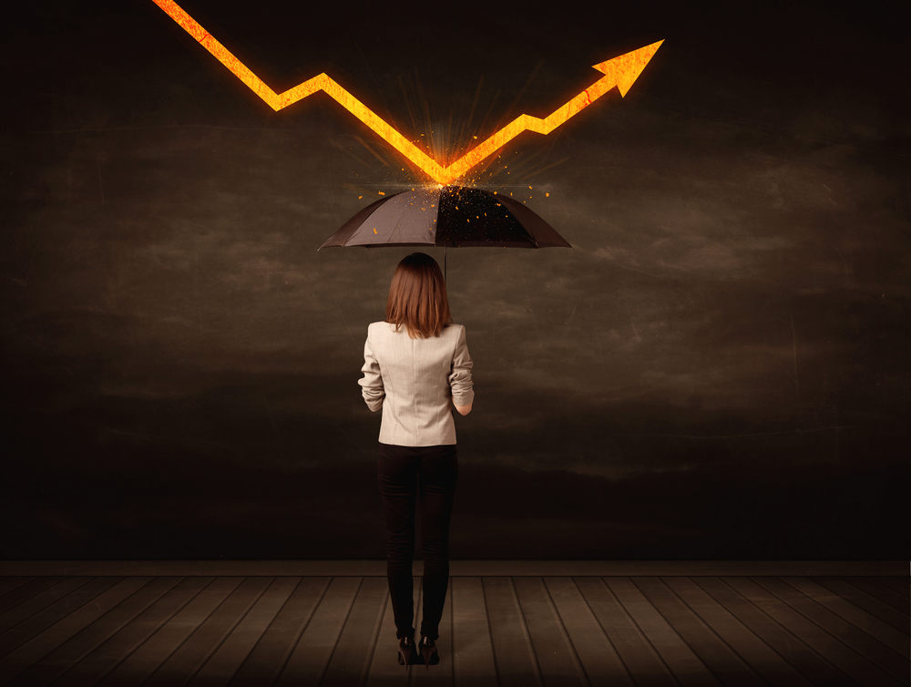 woman standing under an umbrella as a growth chart bounces off of the top