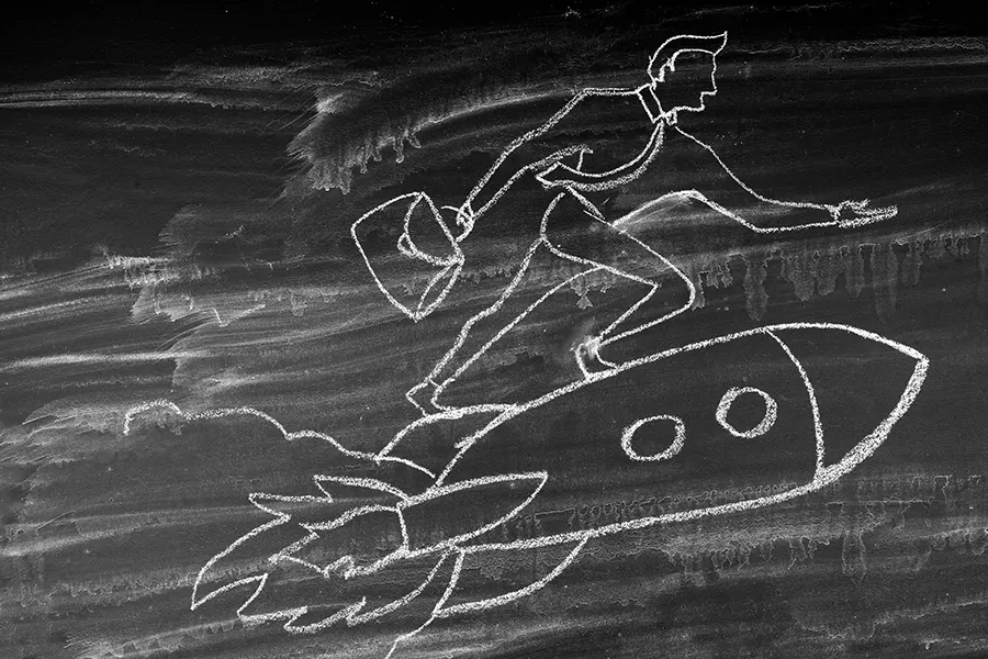 chalk drawing of a man on a rocket ship